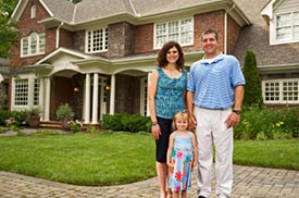A couple standing in front of their New Jersey home after their pest control treatment.